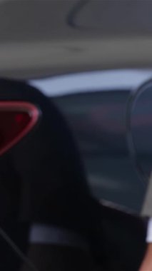 Heyecan verici bir an yaşanıyor. Bir araba satıcısı çarpıcı yeni bir aracın anahtarlarını veriyor. Genç bir çiftin hayallerini somutlaştırıyor. Bu dinamik sahne neşe ve beklenti saçıyor, modern bir galerinin arka planında geçiyor.