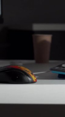 Kesilmiş bir atış, kararlı bir adamı, parlak koltuğuna yerleşmiş, bilgisayarına bağlanmaya hazır bir şekilde yakalar. Eli, modern, iyi ışıklandırılmış çalışma alanındaki verimliliğin özünü somutlaştıran masanın üzerinde güven içinde duruyor.