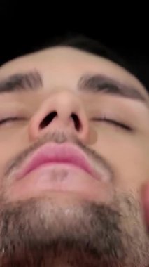 Yetenekli bir berber yakışıklı bir erkek müşteriye, modaya uygun bir berber dükkanının şık atmosferine sarılı bir yüz masajı yapar. Klasik dekor ve yumuşak ışıklandırma, sakin bir atmosfer yaratıyor. Kişisel bakım için mükemmel bir ortam.