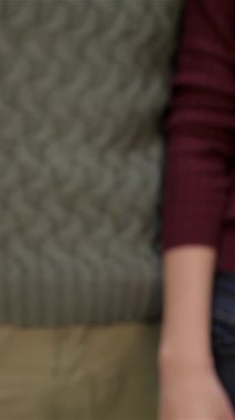 Noel Baba şapkaları ve rahat kazaklar giyen neşeli bir çift, yeni dairelerinin anahtarlarını yumuşak beyaz bir zemin üzerinde gururla sergiliyor. Işıl ışıl gülüşleri ve sevgi dolu jestleri sıcaklığı ve neşeyi yansıtıyor.