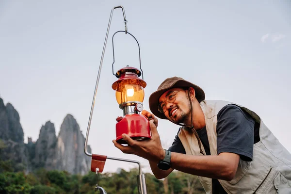 Asian man lanterns are lit lantern for light. Outdoor Camping Concept.