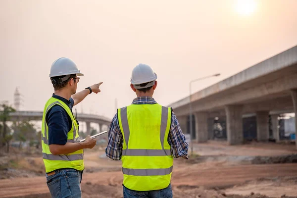 建築家とアジアの建設エンジニアは 建設現場で道路の建設を指します 土木技術者 — ストック写真
