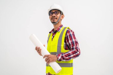 Gülen mimar beyaz arka planda kafasında güvenlik kaskıyla geleceğe dair bir plan tutuyor. İnşaat konsepti.