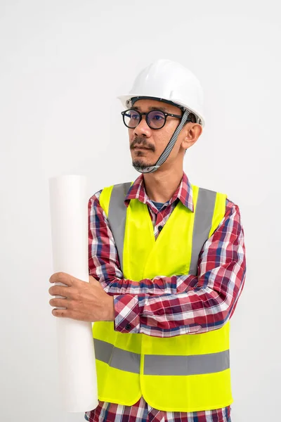 Asian bearded contractor with safety helmet on head in vest standing with arms crossed on white background. Construction contractor