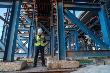 İnşaat mühendisi inşaat halindeki otoyolun yapısını inceliyor.. 