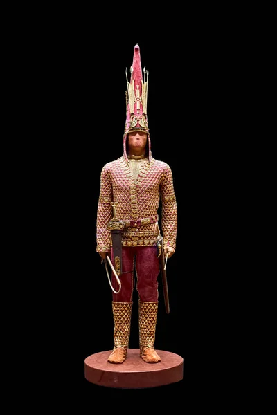 Reconstruction of an archaeological find - the Kazakh Golden Man on a black background.Kazakh Golden Man. Archaeological find. Kazakh artifact. It represents the remains of a Saka warrior in golden clothes.
