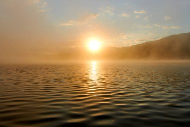 Doğu Kazakistan 'daki Yazevoe Gölü üzerinde atmosferik sabah sisi. Yazevoe Gölü deniz seviyesinden 1685 metre yükseklikte yer almaktadır. Eyalet Ulusal Doğal Parkı 