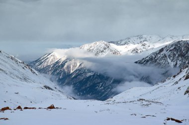 Landscape in Trans-Ili Alatau on a winter day.Trans-Ili Alatau, is a part of the Northern Tian Shan mountain system in Kazakhstan and Kyrgyzstan. clipart