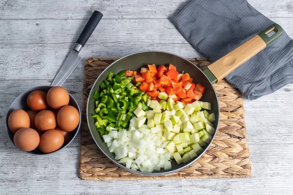 Kızarmış yumurta malzemeleri, kırmızı ve yeşil biber, soğan, kabak ve yumurta ile birlikte Pisto Manchego (Manchego ratatouille). İspanya 'nın tipik ve geleneksel yemeklerini düşünün. Yatay fotoğraf ve seçici odak