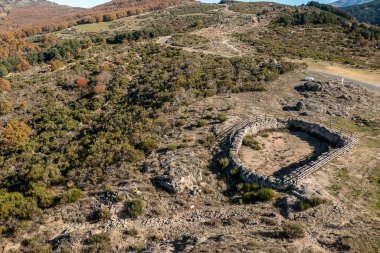 Aerial view Drone landscape autumnal mountainous with sun with resting area and shelter for animals, trees, plants and rocks in the north of Extremadura, Spain. Free life, travel and adventure concept
