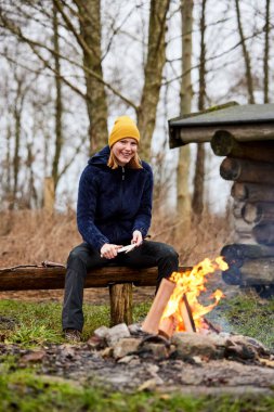 Young woman camping outdoors in nature