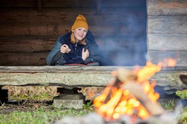 Young woman camping outdoors in nature