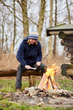 Young woman camping outdoors in nature