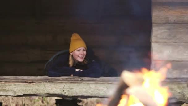 Young Woman Outdoors Shelter Cutting Wood — Video