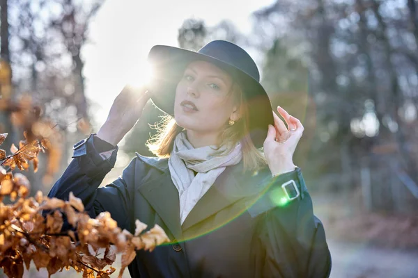 stock image Young woman in forest with a hat and sunshine