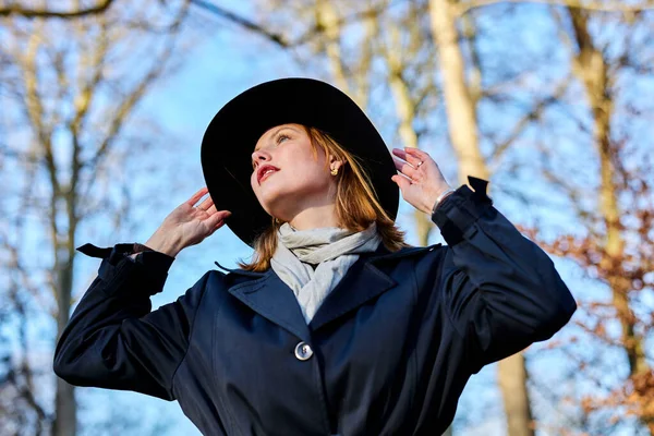 Stock image Young woman in forest with a hat and sunshine