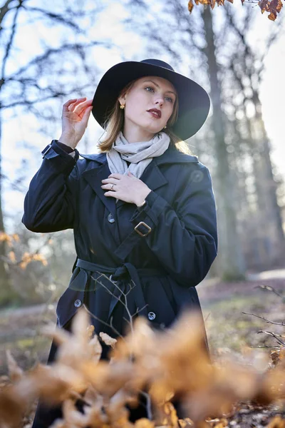 stock image Young woman in forest with a hat and sunshine