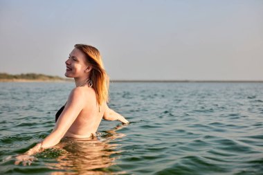 Kumsalda yürüyen kız.