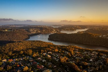 Northern Beaches Sydney NSW Avustralya 'nın banliyöleri üzerinde gün batımı drone görüntüsü