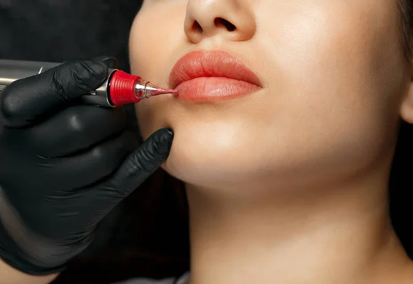 Closeup shot of a woman lips with permanent makeup at cosmetic salon