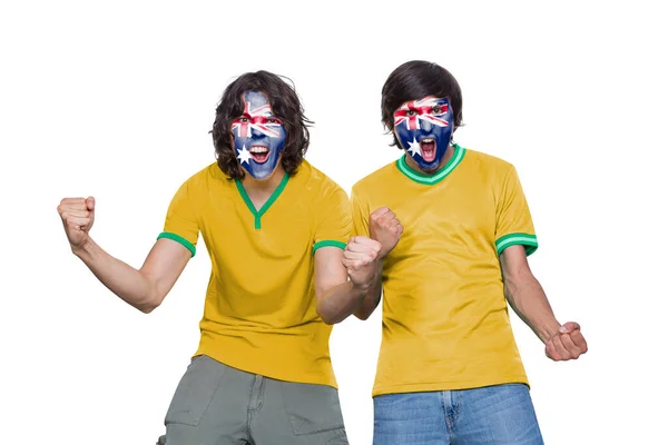两名球迷身穿球衣 脸上涂满了澳大利亚代表队的旗帜 他们激动地尖叫着 背景是白色的 — 图库照片