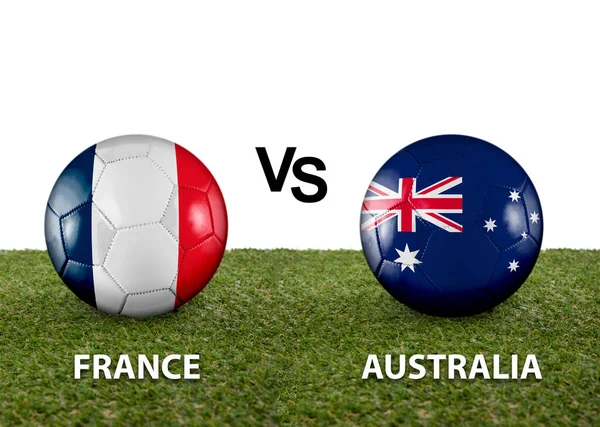 stock image Two balls with the flags of rival countries France vs Australia on the grass of a Qatar 2022 world cup soccer field on a white background.