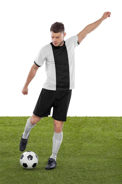 Professional soccer player with white and black Germany national team jersey about to score a goal with an expression of challenge and decision on his face on white background.