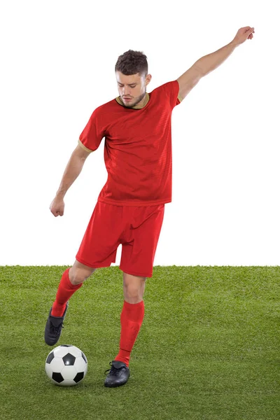 Professional soccer player with red Serbia national team jersey about to score a goal with an expression of challenge and decision on his face on white background.