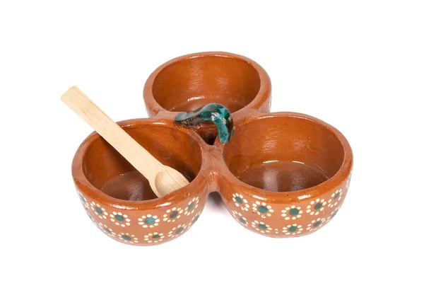 Tableware with divisions of red clay made in Mexico. Traditional handmade Mexican clay crockery. isolated White background.