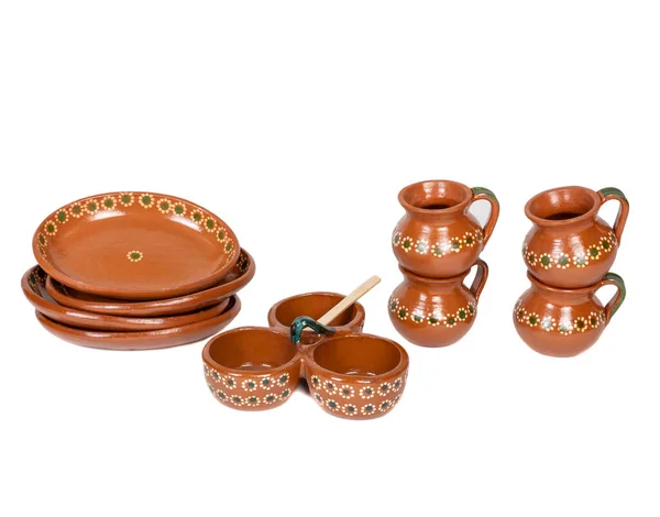 Tableware of several pieces of red clay made in Mexico. Traditional handmade Mexican clay crockery. isolated White background.