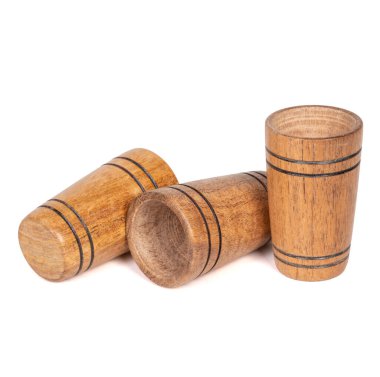 Three Handmade artisan wooden glasses for drinking wine, tequila, vodka, water, isolated on a white background.
