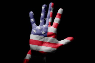 Rude man hand with flag of USA in stop sign to anger, discrimination, racism, abuse on black background.