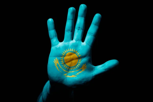 Rude man hand with flag of Kazakhstan in stop sign to anger, discrimination, racism, abuse on black background.