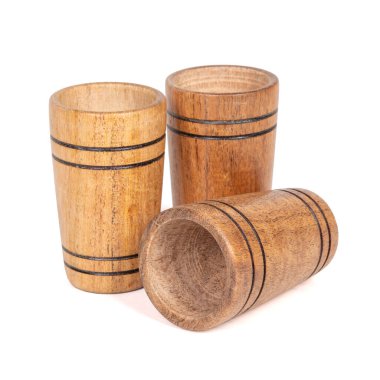 Three Handmade artisan wooden glasses for drinking wine, tequila, vodka, water, isolated on a white background.