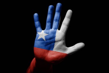 Rude man hand with flag of Chile in stop sign to anger, discrimination, racism, abuse on black background.