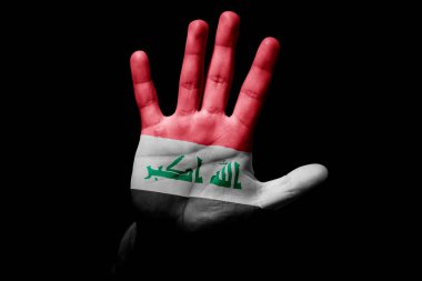 Rude man hand with flag of Iraq in stop sign to anger, discrimination, racism, abuse on black background.