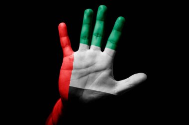 Rude man hand with flag of United Arab Emirates in stop sign to anger, discrimination, racism, abuse on black background.