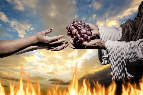 Hands Jesus Christ Giving Someone Bunch Grapes Background Fire Cloudy — Zdjęcie stockowe