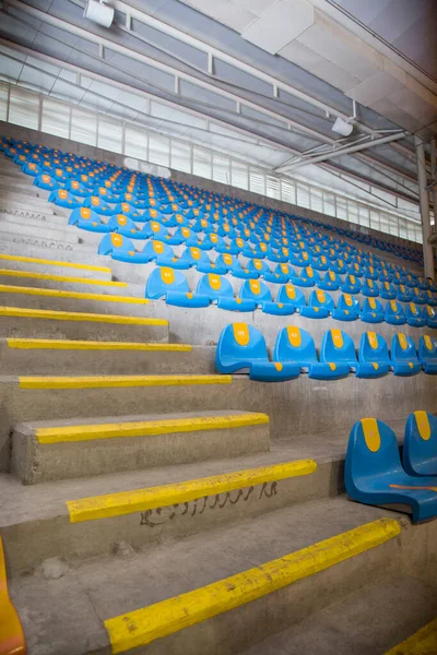 stock image blue bleachers in stadium in a circular shape and in rows