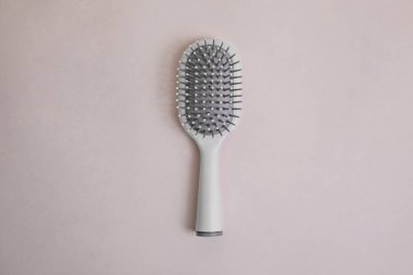 Bej arka planda gri detaylar içeren gri plastik tarak