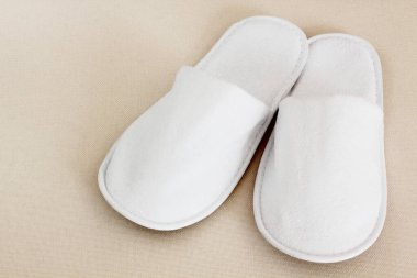 Beyaz terliklerin yakın görüntüsü. Balneo, spa, otel, ev konsepti