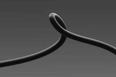 Siyah bir kablo, pürüzsüz dokusu ve şeklini gösteren bir döngü oluşturur.