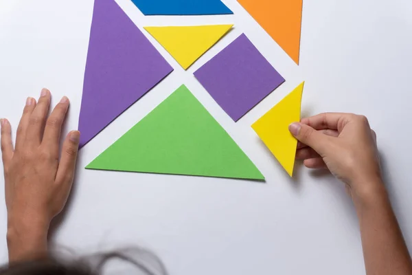 Tangram, Puzzle game for children made with colored cardboard. education and teaching