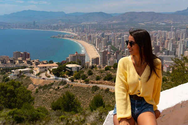 Pretty young girl at the Mirador de la Cruz in Benidorm, Spain. Mediterranean city on summer vacation.