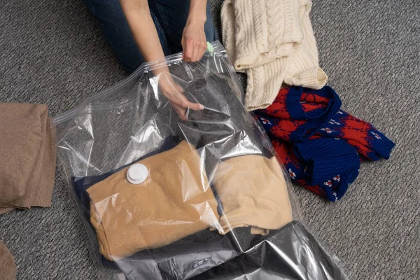 Young Woman Folds Warm Sweaters Transparent Vacuum Bag Storage Concept — Stock Photo, Image