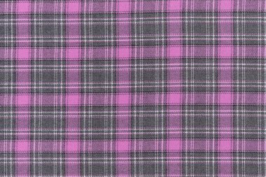 Pembe ve gri tartan kumaşın yakın çekim dokusu. Tasarımın için arka plan. Geleneksel İskoç kıyafeti ve tarzı