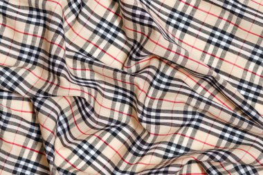 Buruşuk Burberry damalı bej, kırmızı ve siyah kumaş. Tasarımınız için görüntü. 26 Ekim 2023, Kyiv, Ukrayna.