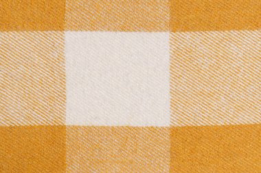Bir tartan hücresindeki hardal sarısı renk için sıcak kumaşın yakın çekim dokusu. Tasarımın için resim