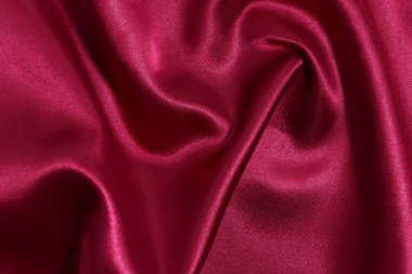 Buruşuk, buruşuk, kırmızı renkli kumaş dokusu, yakın plan parlıyor. Tasarımın için lüks bir arka plan. Dikiş malzemeleri