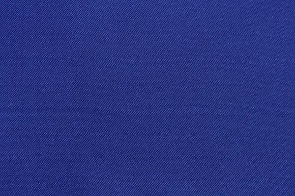 close-up texture of blue twill fabric from synthetics. background for your design